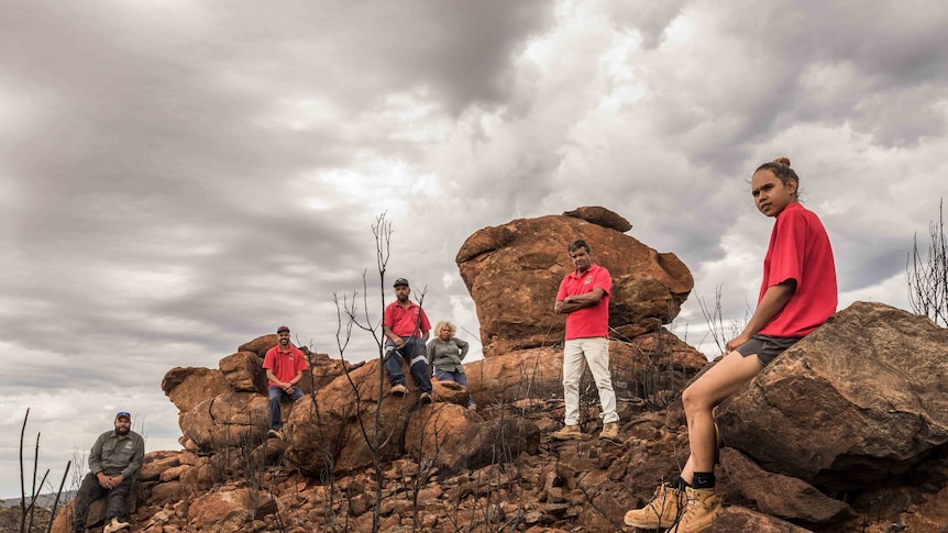 Aboriginal people on their traditional lands after a bushfire.