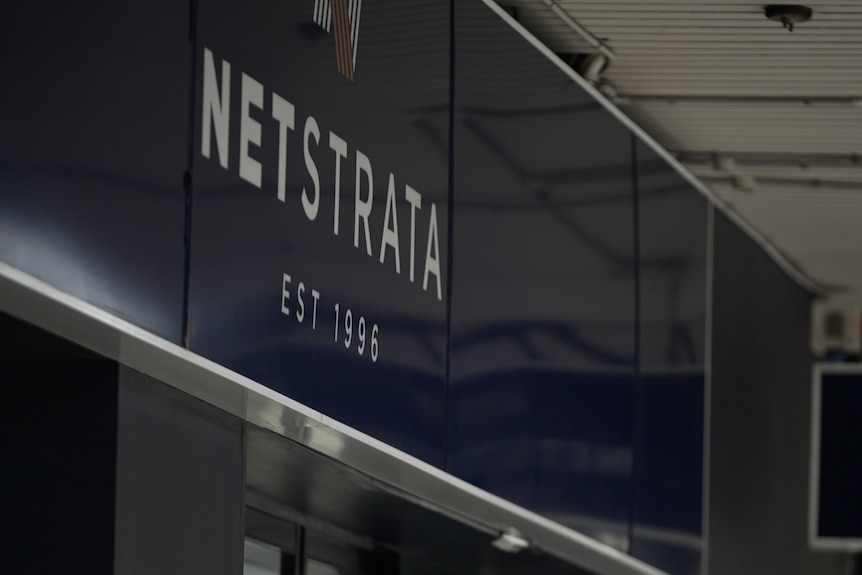 a sign outside a building that reads netstrata