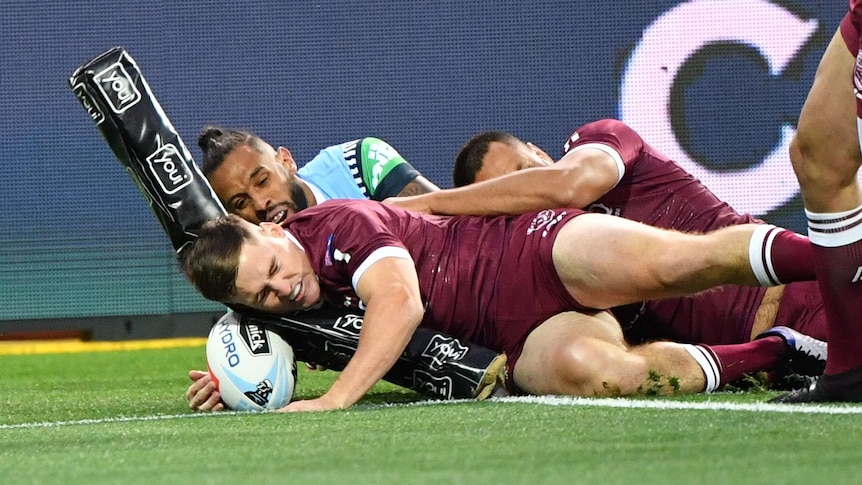 Josh Addo-Carr is pushed into touch by Kurt Capewell