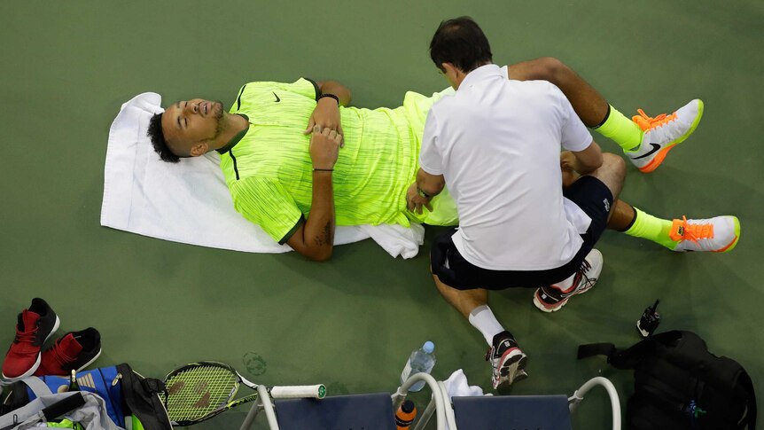 Australia's Nick Kyrgios receives medical attention against Britain's Aljaz Bedene at the US Open.