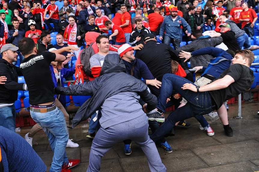 Sevilla and Liverpool fans fight in the stands