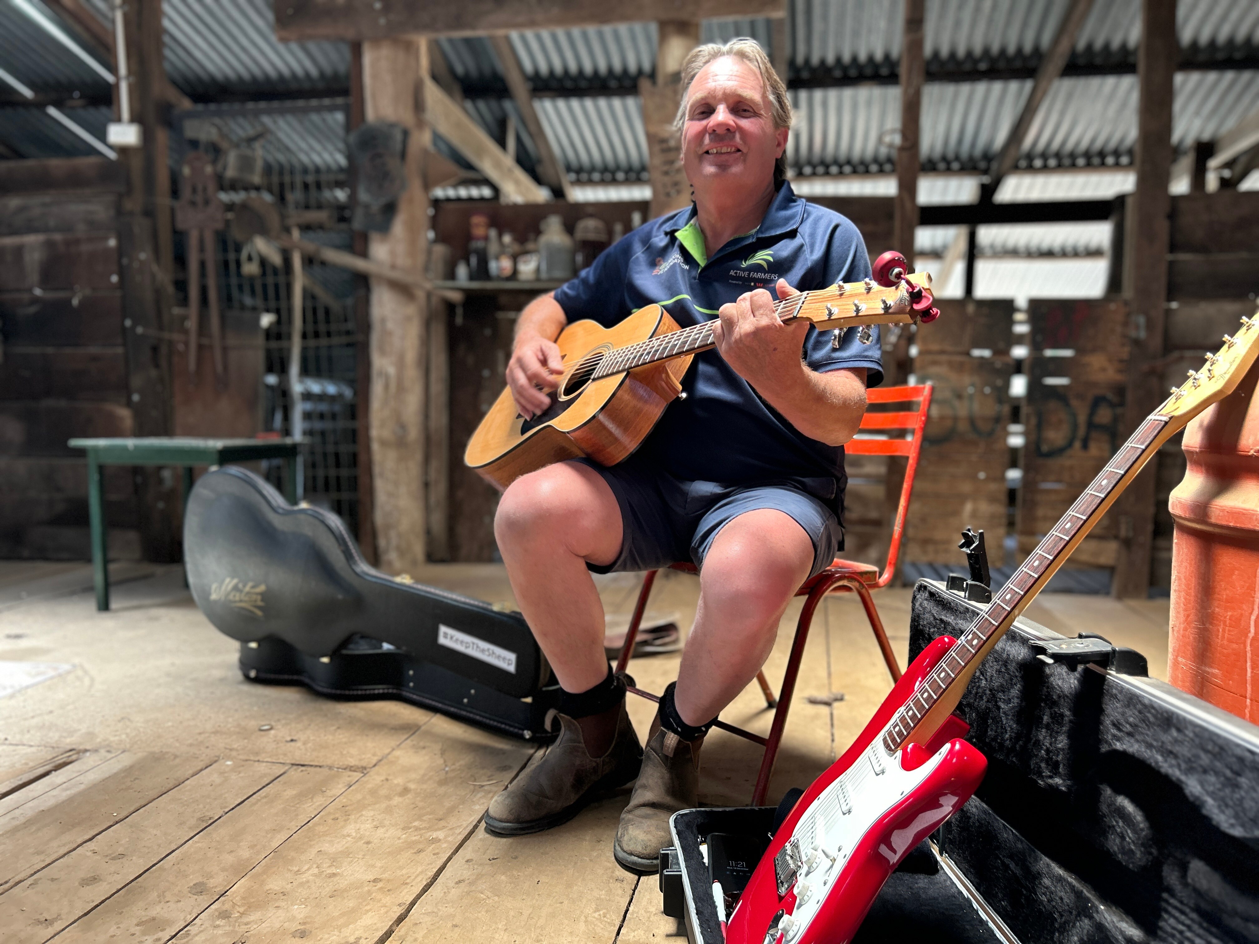 Man sits in shearing shed in regional western australia.