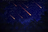 Glowing orange meteors in the sky.