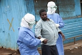 Nurses escort an Ebola patient in Monrovia, Liberia.
