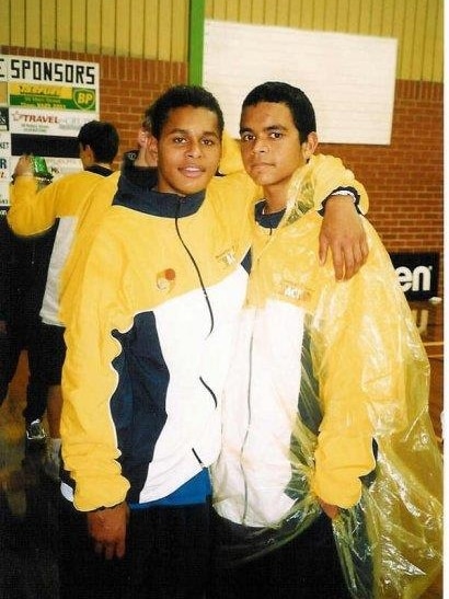 A photo of Patty and Luke when they were kids, wearing bright yellow Canberra Shadows jackets.