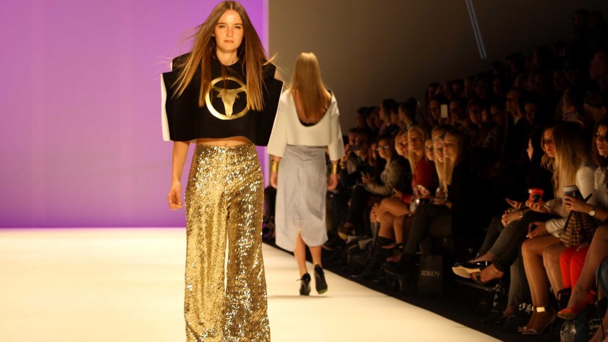 A model walks the runway showcasing a design by Phoenix Keating during Australian Fashion Week.