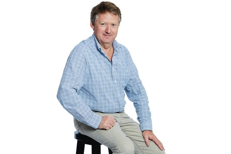 A man sitting on the chair on a white background profile shot