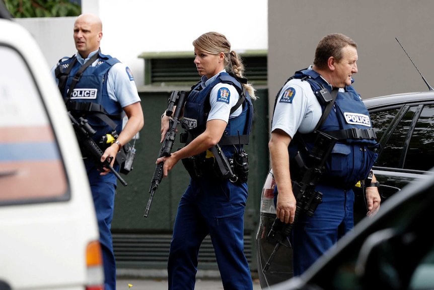 Group of armed police officers waiting outside.