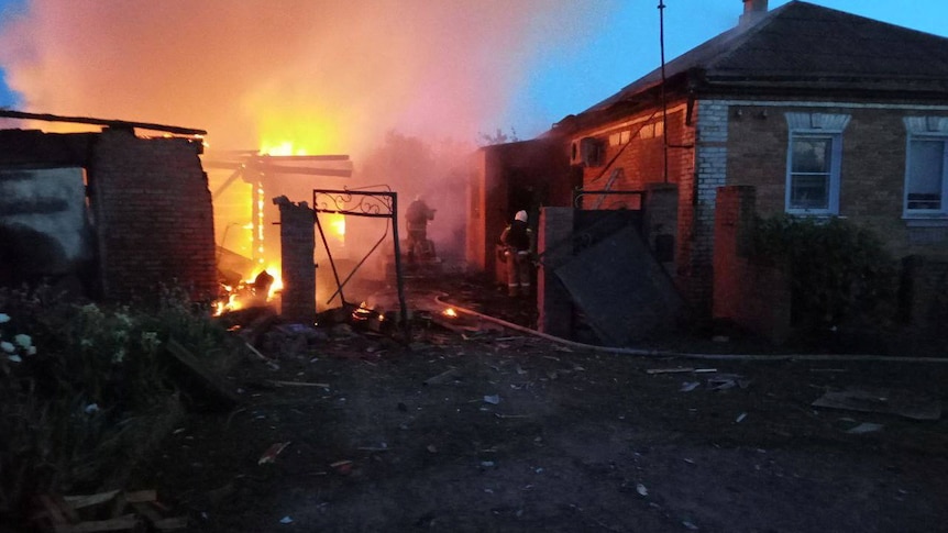 House on fire in the early morning, after shelling which has damaged buildings in a village.