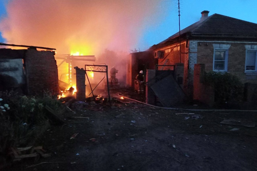 House on fire in the early morning, after shelling which has damaged buildings in a village.