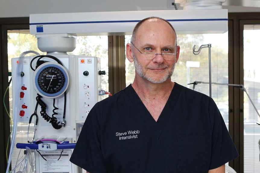 Professor Steve Webb stands in front of medical equipment