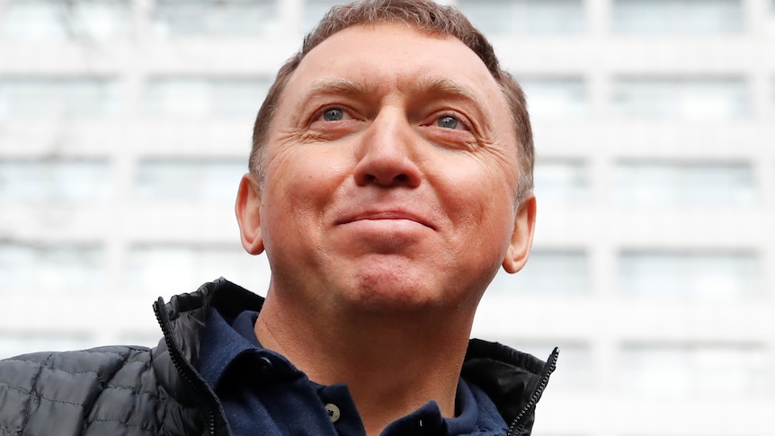 Oleg Deripaska in a black puffer with a slight smile on his face 