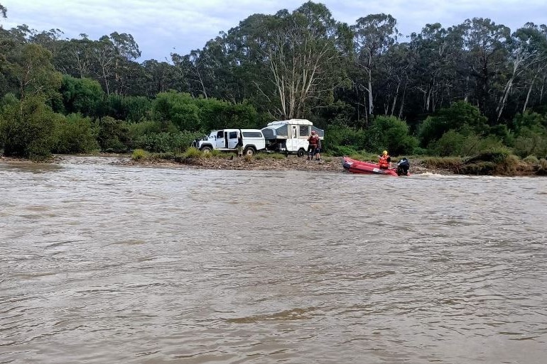 caravan isolated by river and SES boat