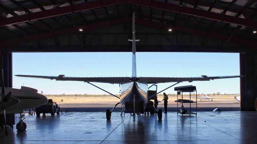 A plane sits inside an open hangar at ChartAir in the Northern Territory.