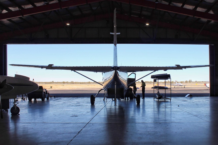 A plane sits inside an open hangar at ChartAir in the Northern Territory.