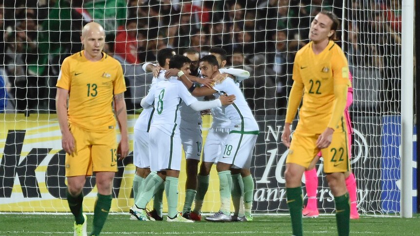 Socceroos' Aaron Mooy and Jackson Irvine look on as Saudi Arabia celebrates equaliser