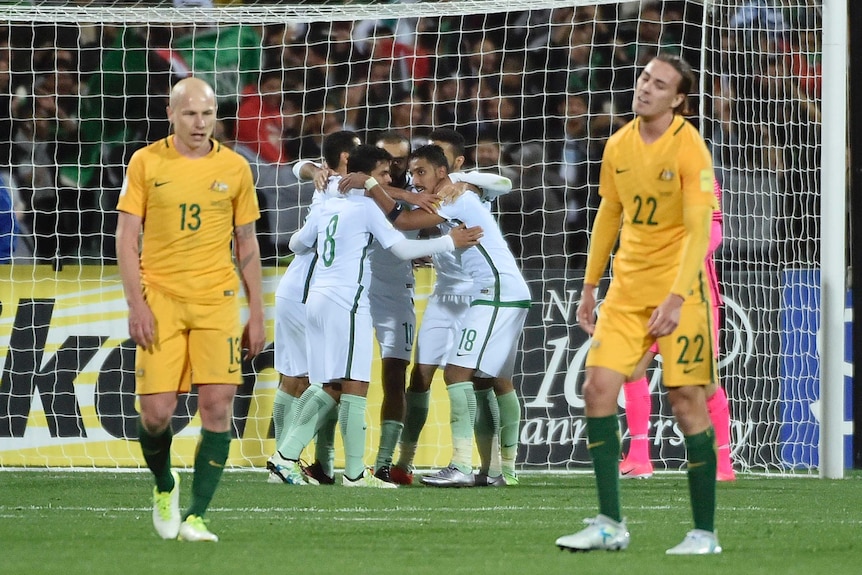 Socceroos' Aaron Mooy and Jackson Irvine look on as Saudi Arabia celebrates equaliser