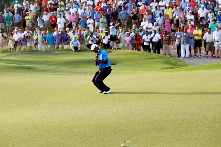 Tiger Woods reacts after missing a putt on the 18th green during the second round.