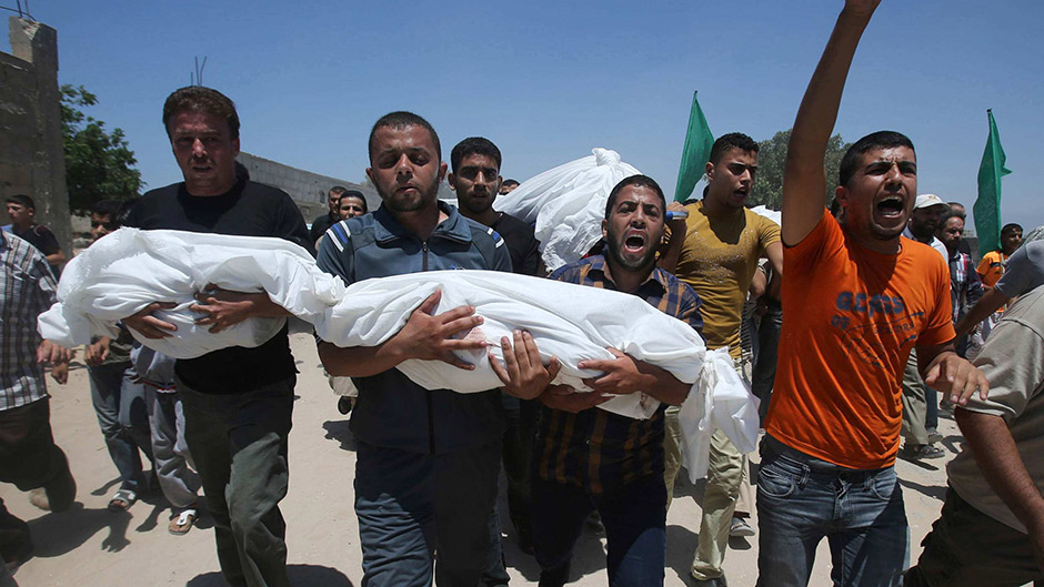 Mourners carry the bodies of Palestinian children, whom medics said were killed in an Israeli air strike.