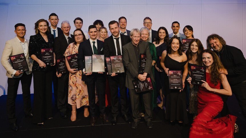 Group shot of Clarion Award Winners with their plaques