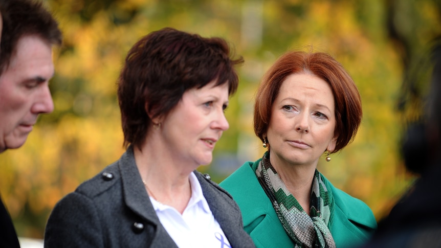 Mother of a bullying victim and the then prime minister at a news conference.