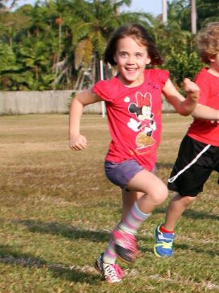 A five-year-old participates in a running race at a Darwin school