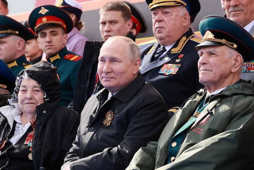 Russian President Vladimir Putin watches a military parade on Victory Day