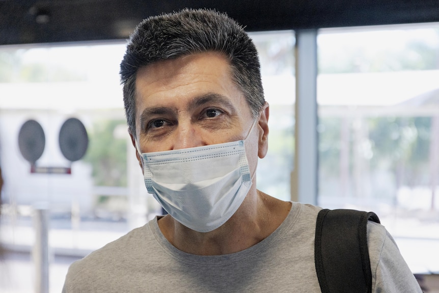 Carlos Rodriguez at the Darwin Airport, wearing a mask, before his flight to Perth.