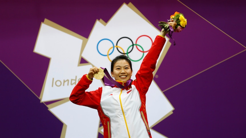 London opener ... Yi Siling shows off her gold medal