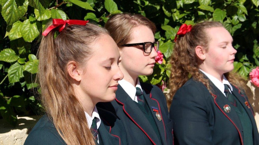 Sophie Farmer, Ciara Pedrotta-Parsons and Sofia Alessandrini meditate at Santa Maria College