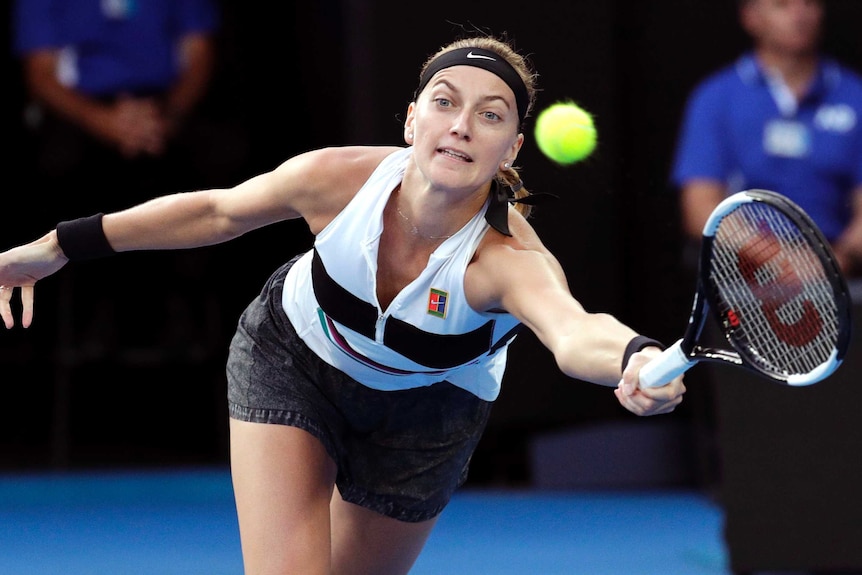 Petra Kvitova stretches for a forehand return against Naomi Osaka.