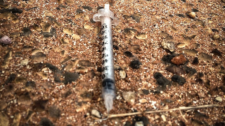 A discarded syringe on a Broome street.