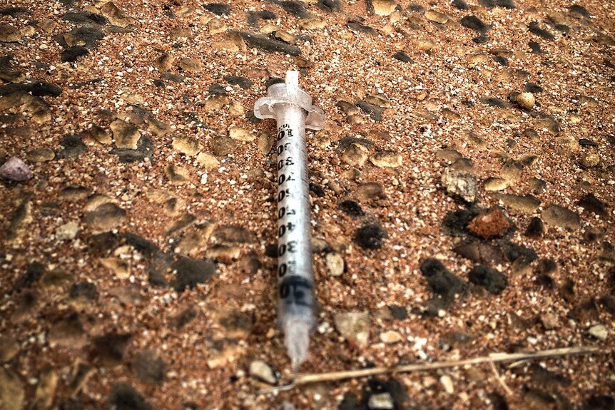 A discarded syringe on a Broome street.