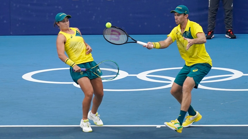 Australian tennis player Ash Barty sways out of the way of mixed doubles partner John Peers at the Tokyo Olympics.