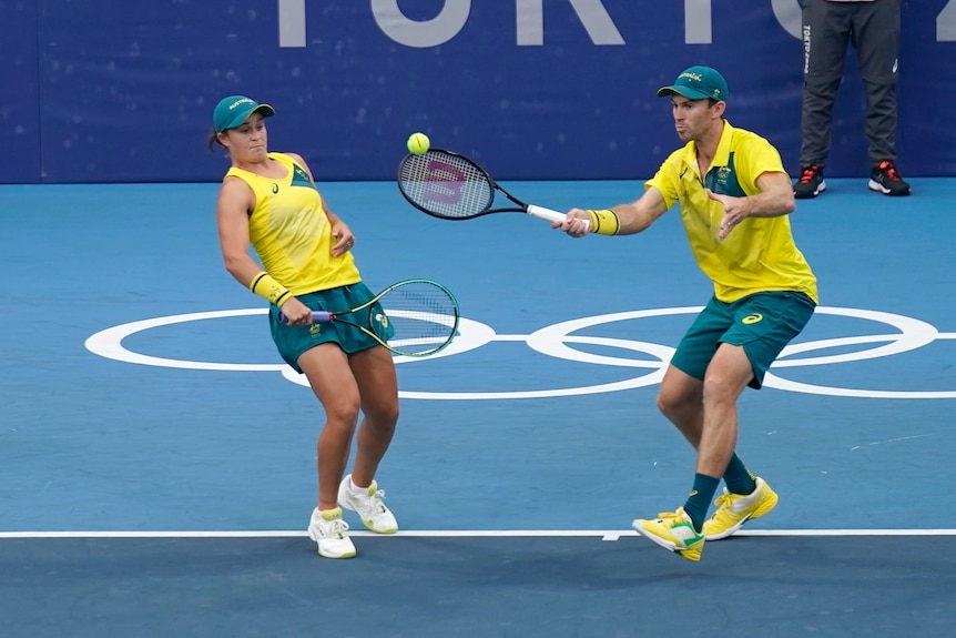 Australian tennis player Ash Barty sways out of the way of mixed doubles partner John Peers at the Tokyo Olympics.