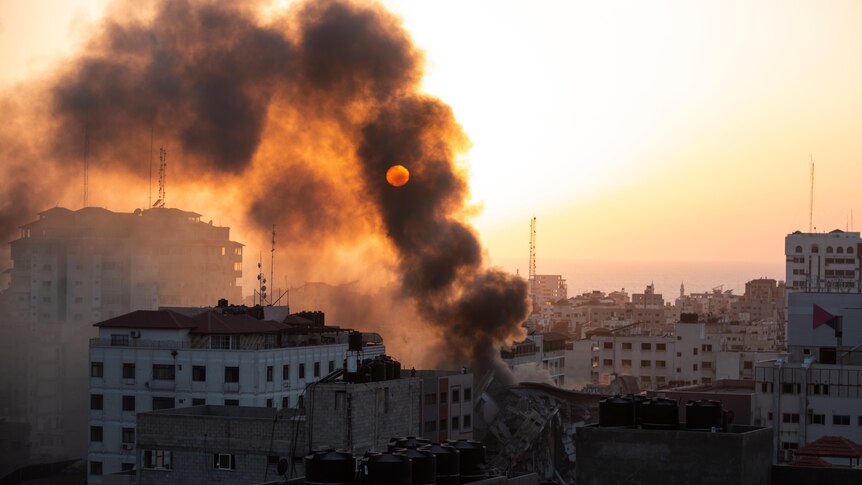 Smoke is seen from a collapsed building after it was hit by Israeli airstrikes.