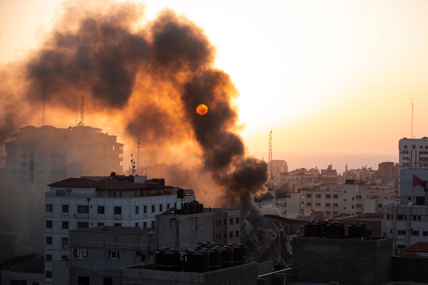 Smoke is seen from a collapsed building after it was hit by Israeli airstrikes.