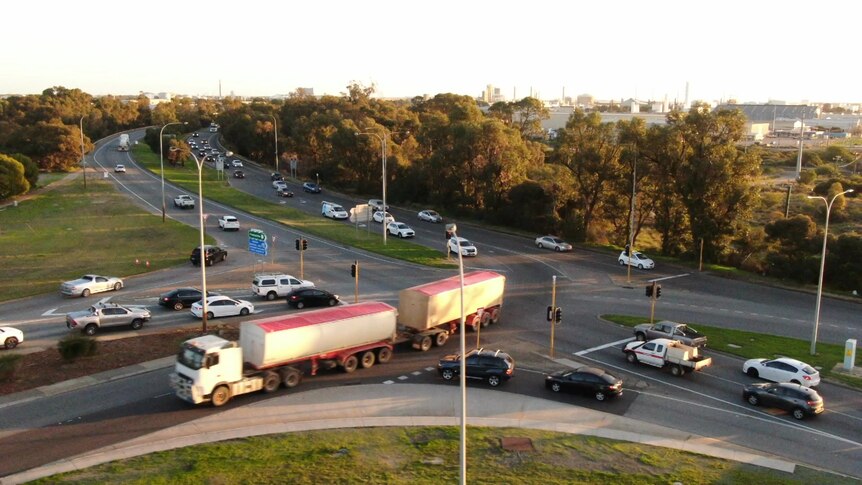 Cars pass through a major highway intersection in Kwinana