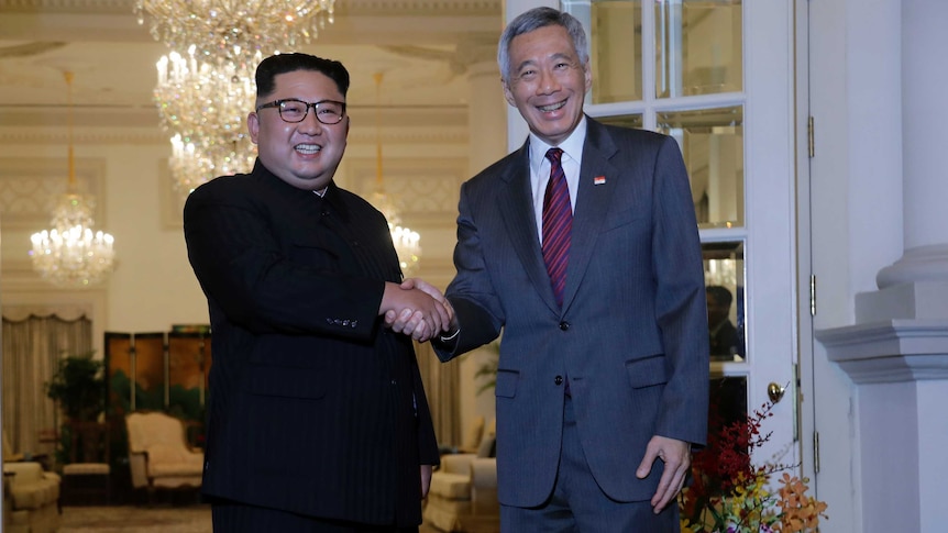 Kim Jong-un, left, shakes the hands of Singapore's Prime Minister Lee Hsien Loong.