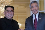 Kim Jong-un, left, shakes the hands of Singapore's Prime Minister Lee Hsien Loong.