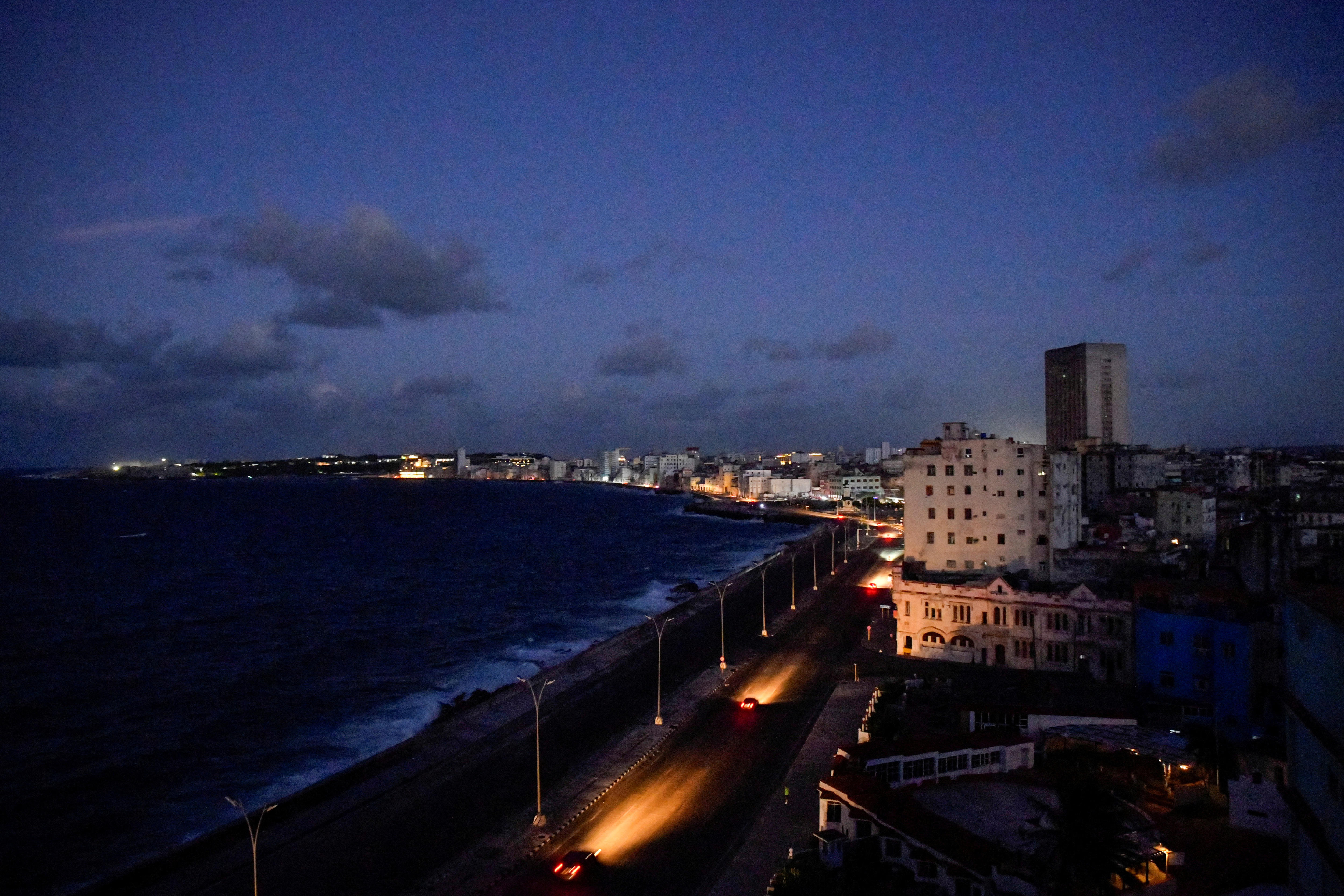 Cars driving on a boulevard during a blackout. 