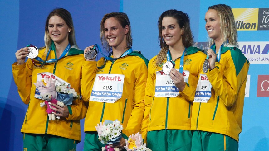 Shayna Jack, Bronte Campbell, Brittany Elmslie and Emma McKeon stand on the podium with their silver medals.