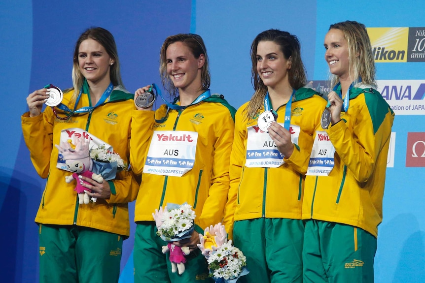 Shayna Jack, Bronte Campbell, Brittany Elmslie and Emma McKeon stand on the podium with their silver medals.