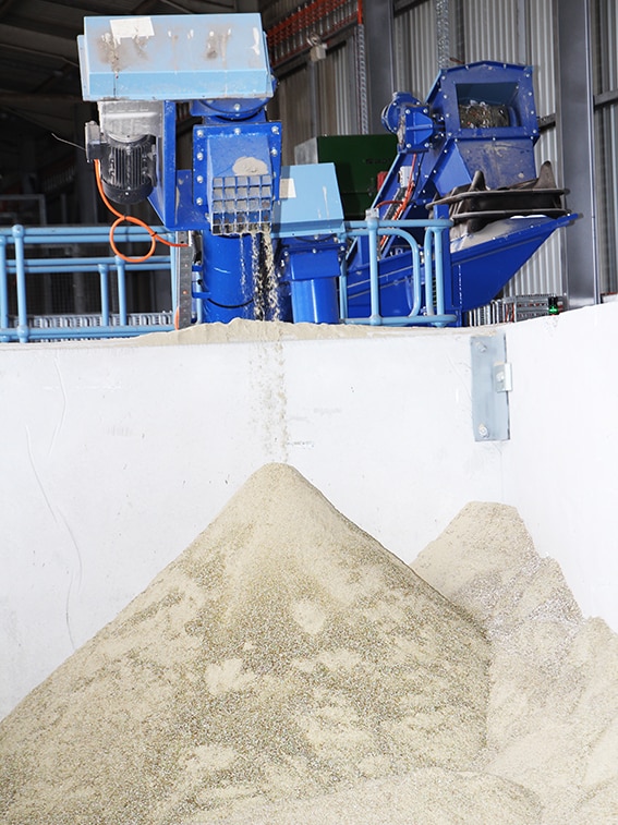 Sand created from crushed glass inside the Lismore glass processing plant