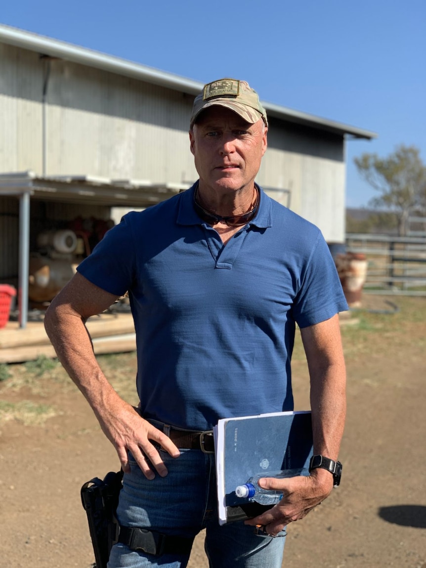 Detective Senior Sergeant Tony Parsons stands on a farm.