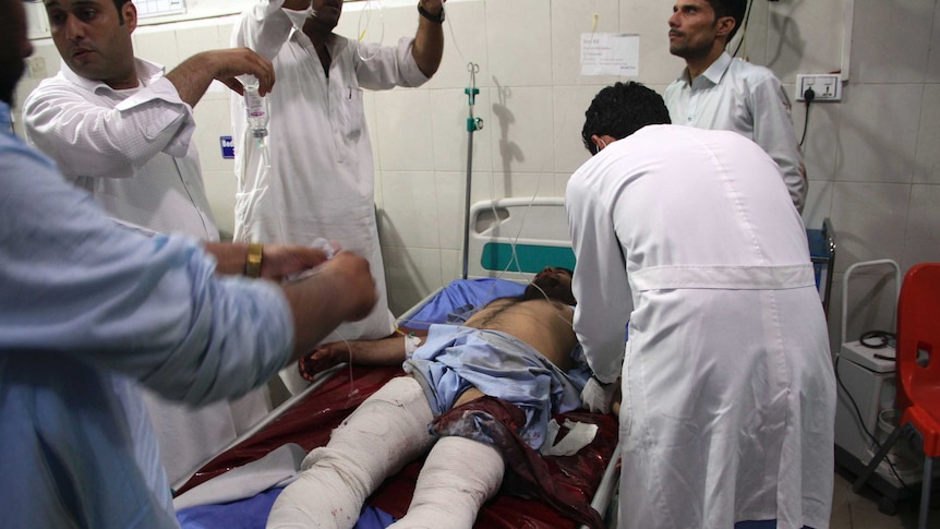 A wounded man receives treatment at a hospital after a suicide car bomb in Jalalabad, Afghanistan.