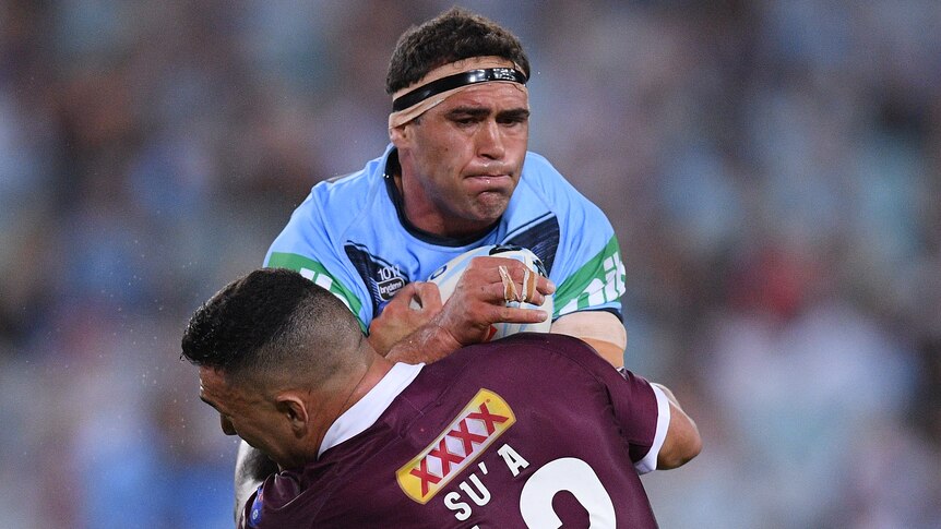 A New South Wales State of Origin forward makes a hit-up against Queensland.