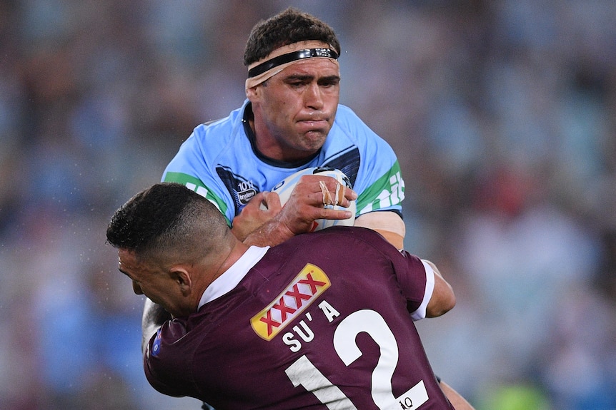 A New South Wales State of Origin forward makes a hit-up against Queensland.
