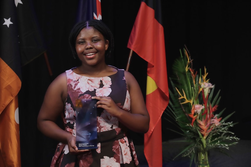 Sizolwenkosi Fuyana stands with her NT Young Australian of the Year award.