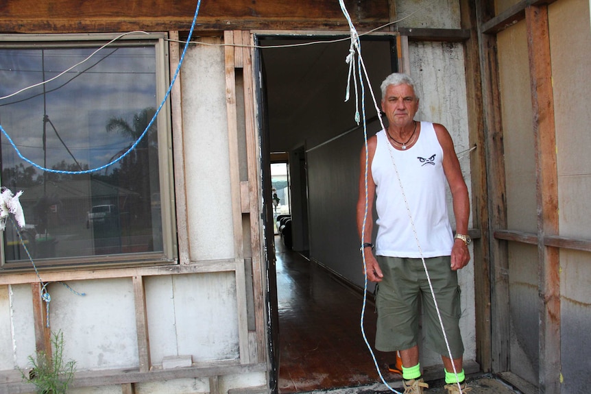 Kurnell resident Shane Jones leans against his tornado-damaged house.